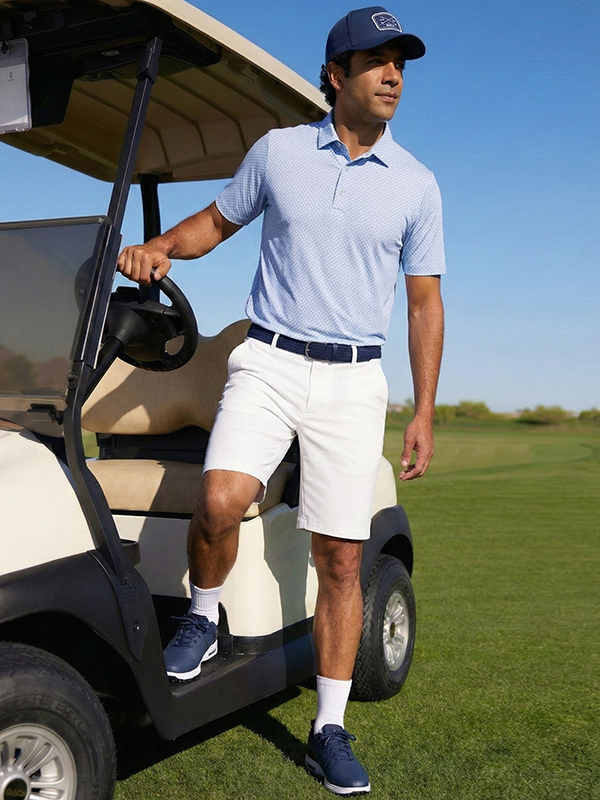 Male Model Wearing Ben Hogan Light Blue Polo with White Shorts and Blue Cap